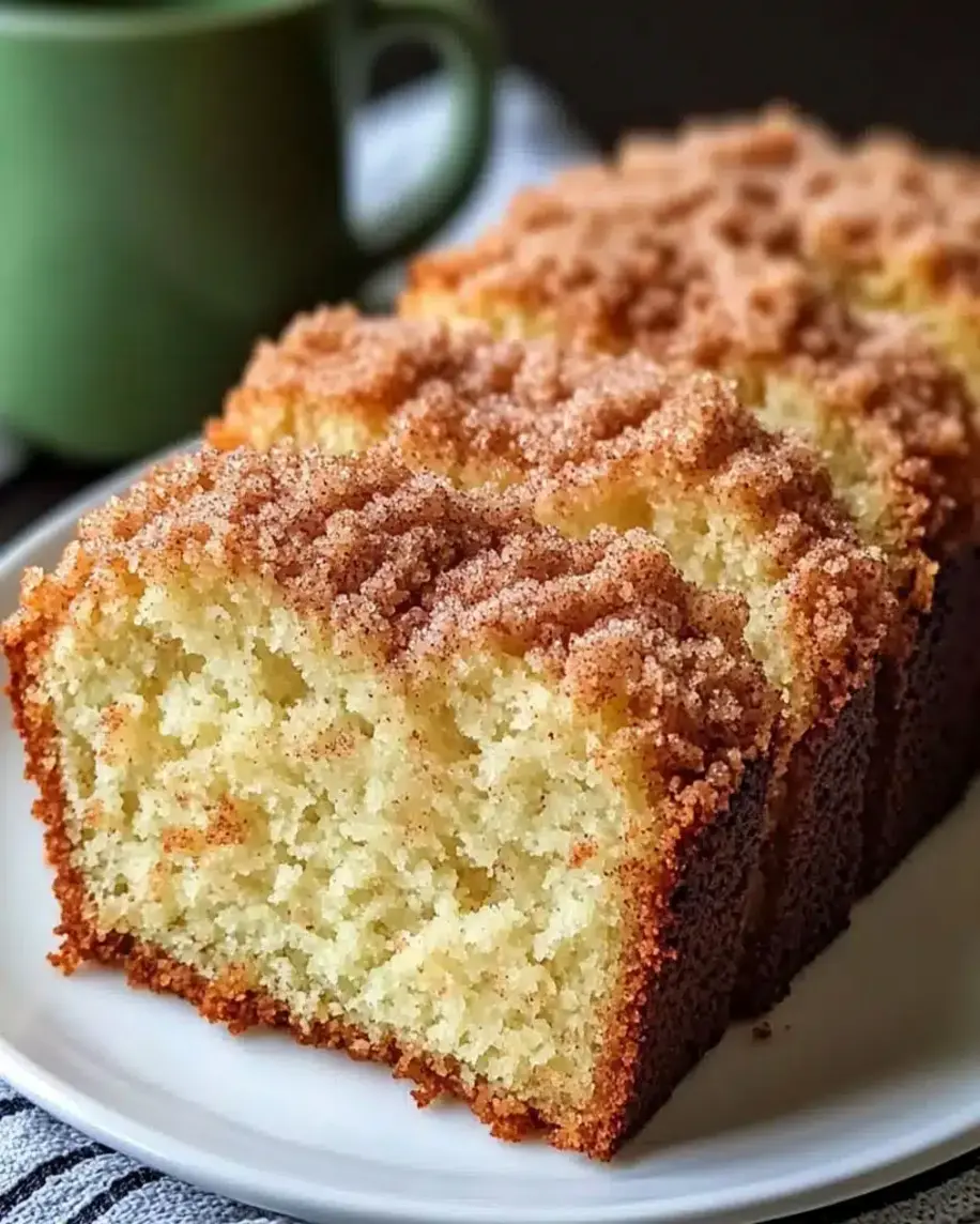 Close-up of Cinnamon Donut Bread being brushed with melted butter and sprinkled with cinnamon sugar.