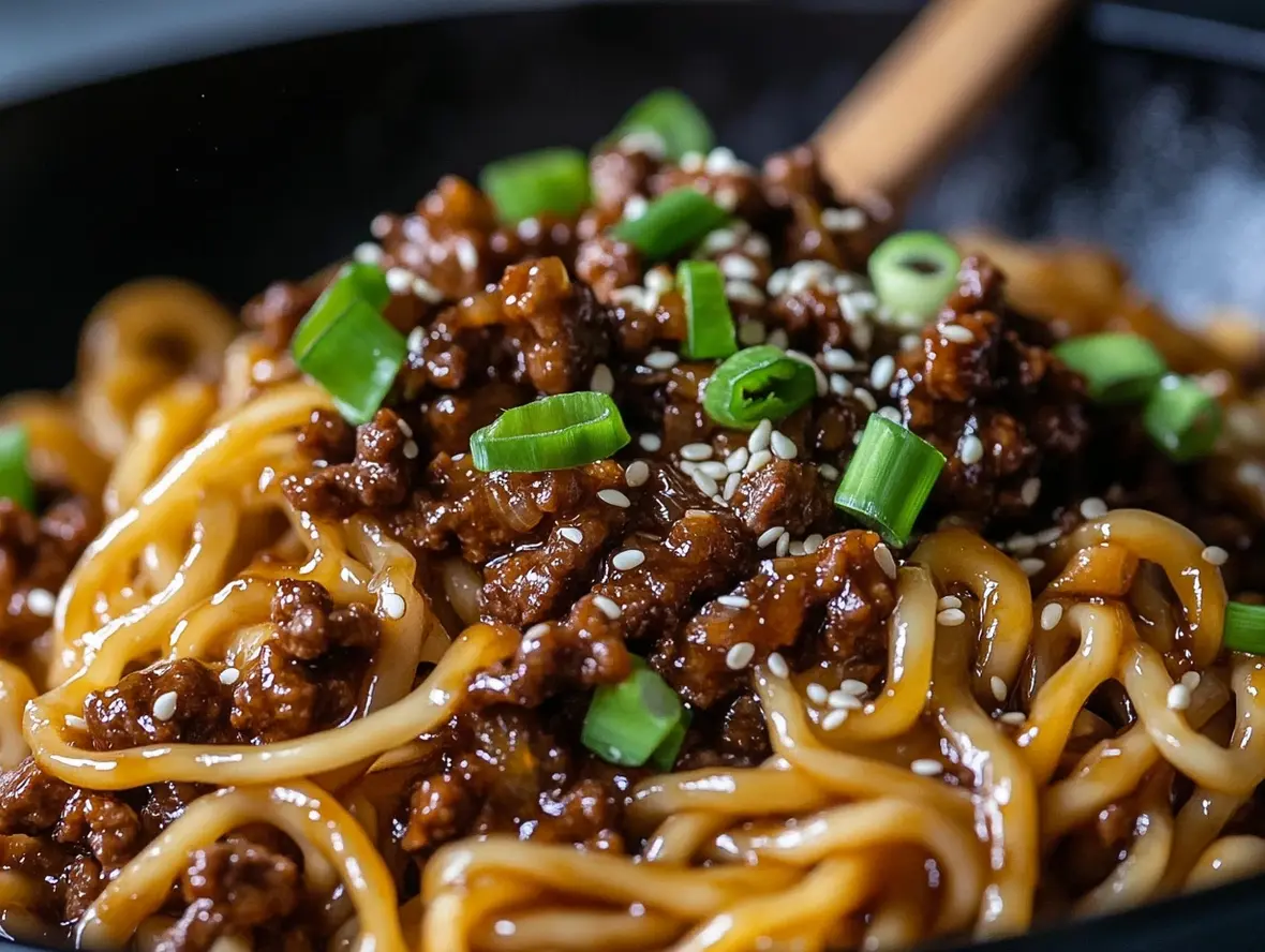 Close-up of Mongolian Ground Beef Noodles, showing the glossy sauce coating the noodles and beef.