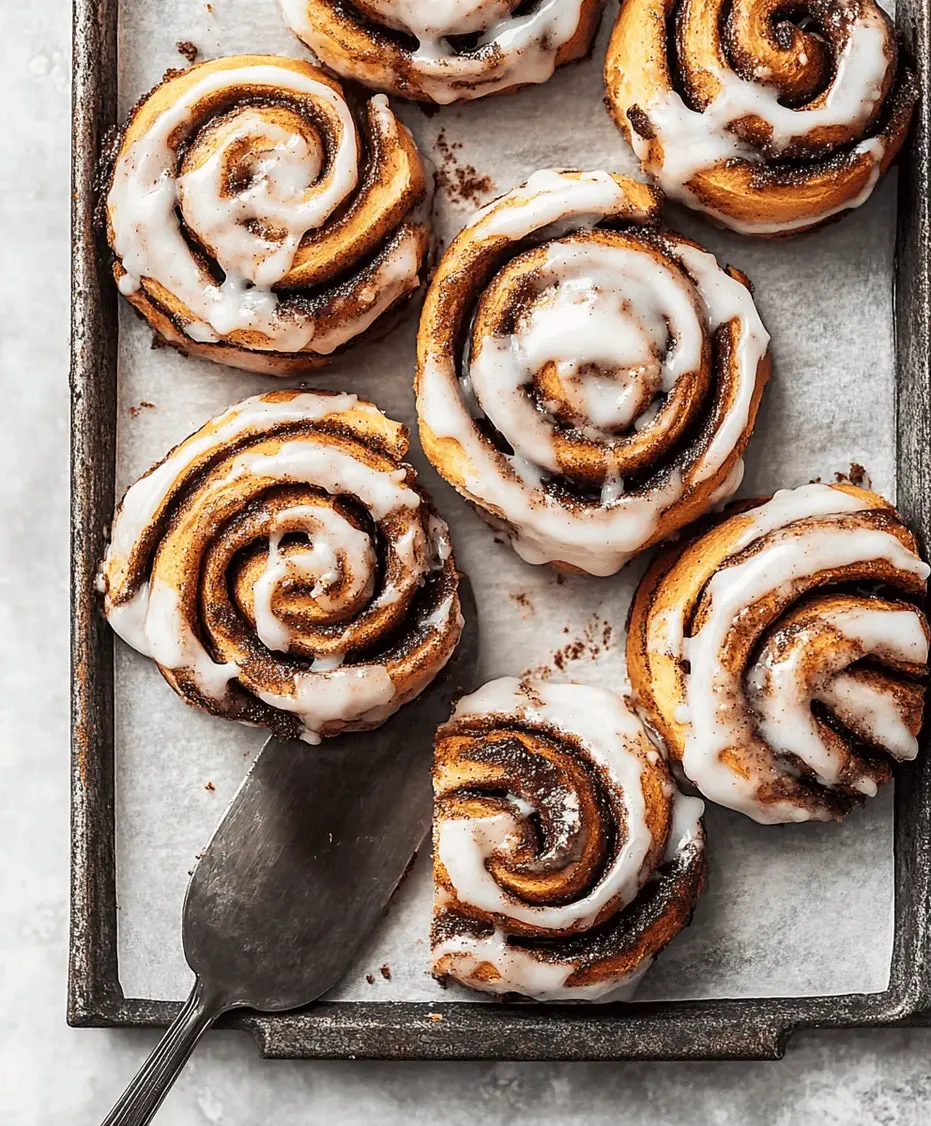 A close-up of a single chai-spiced cinnamon roll with glaze dripping down the sides.