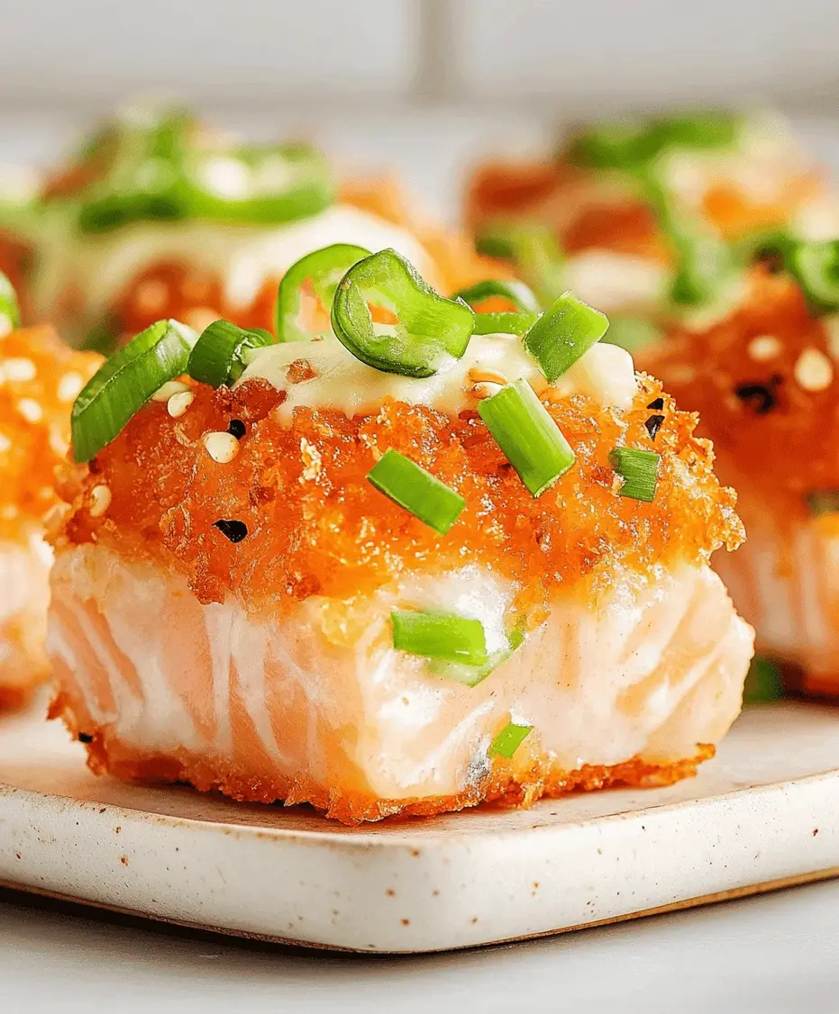 Close-up of crispy spicy salmon bites with lemon wedges