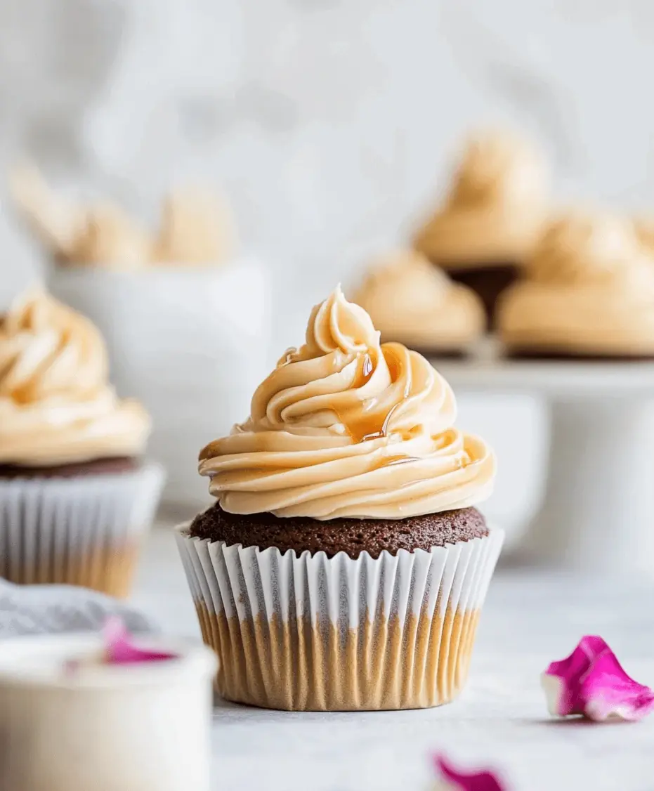 A piping bag filling a cupcake with caramel frosting