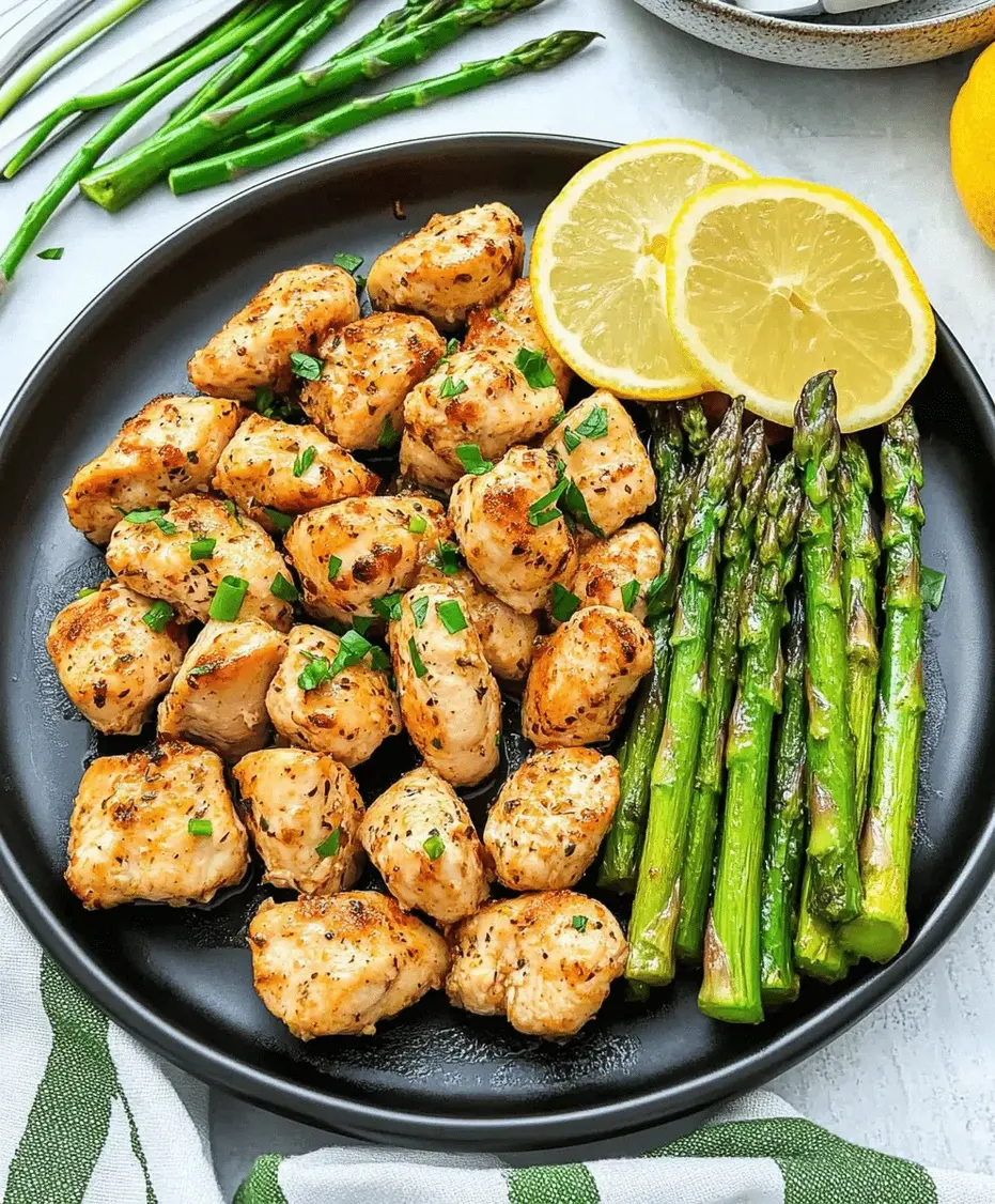 A plate of garlic butter chicken bites with asparagus, garnished with parsley.