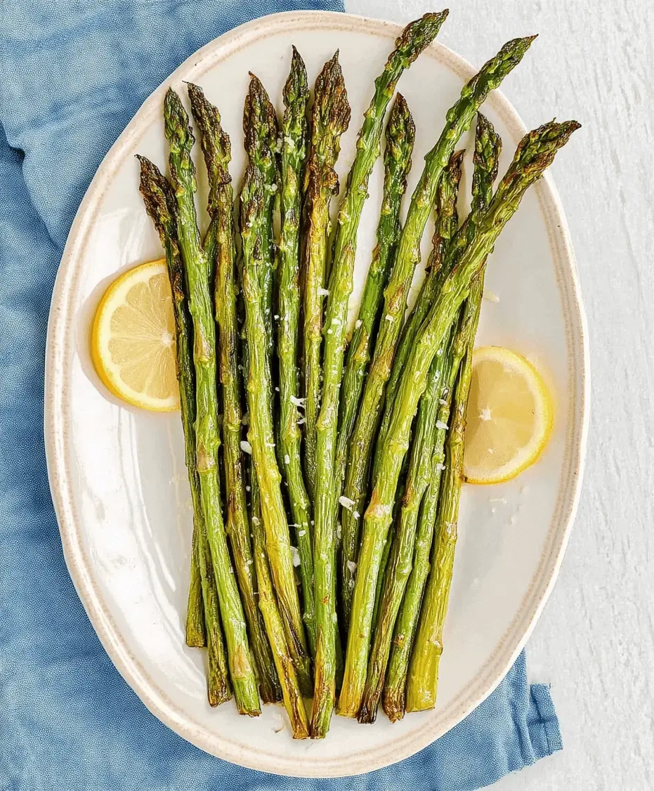 Roasted asparagus with golden Parmesan cheese served on a plate.